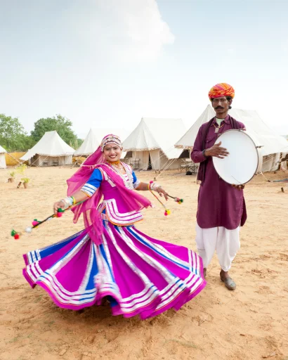 Folk dancer in a pink skirt dancing at the camp