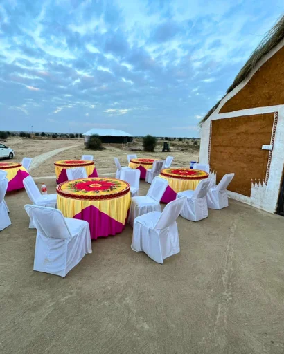 Outdoor dining tables dressed in yellow and pink