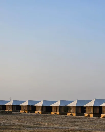 Line of camp tents at dusk