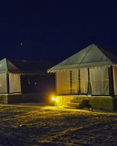 A Swiss tent lit up at night